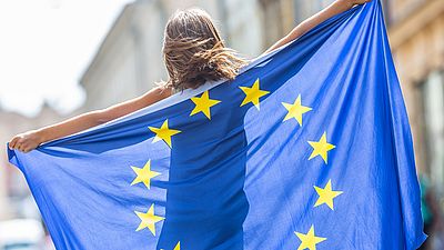 Young woman holding an EU flag